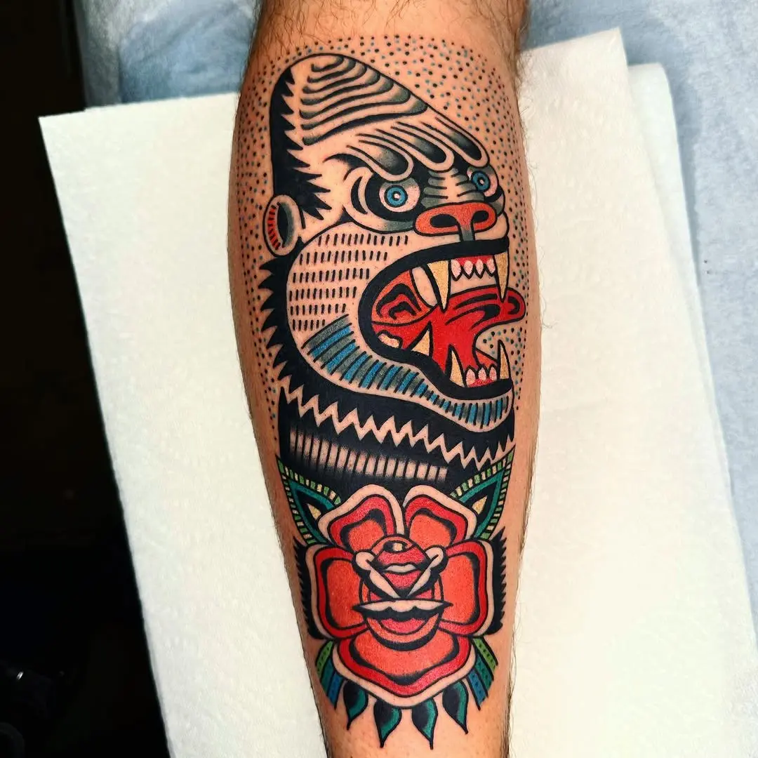 Vibrant gorilla tattoo with floral elements