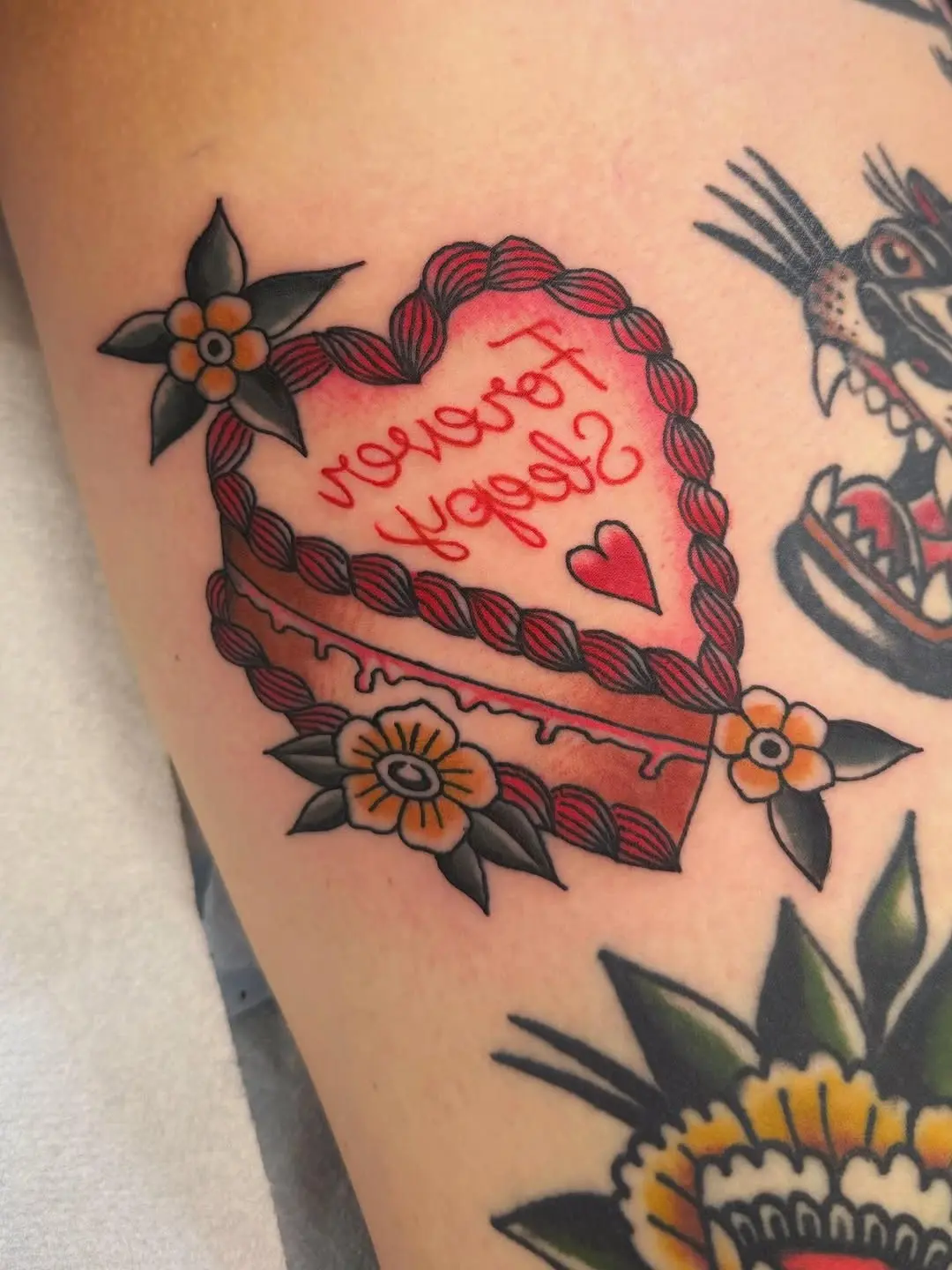 Whimsical heart-shaped cake tattoo design