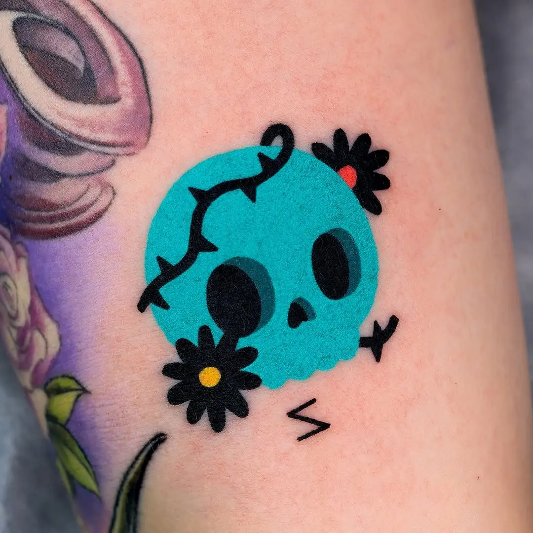 Vibrant skull with floral accents tattoo art
