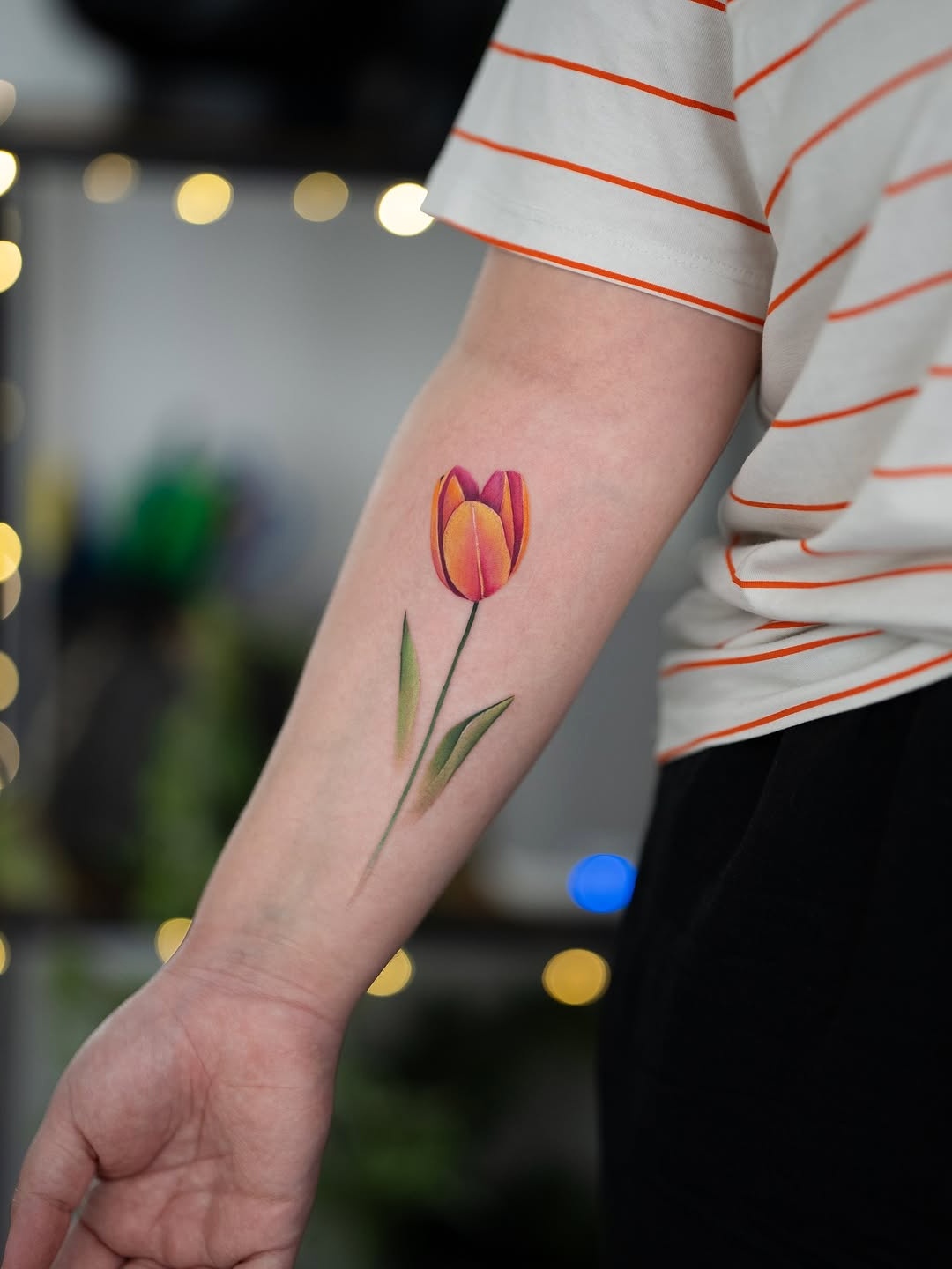 Vibrant tulip tattoo showcasing blooming beauty