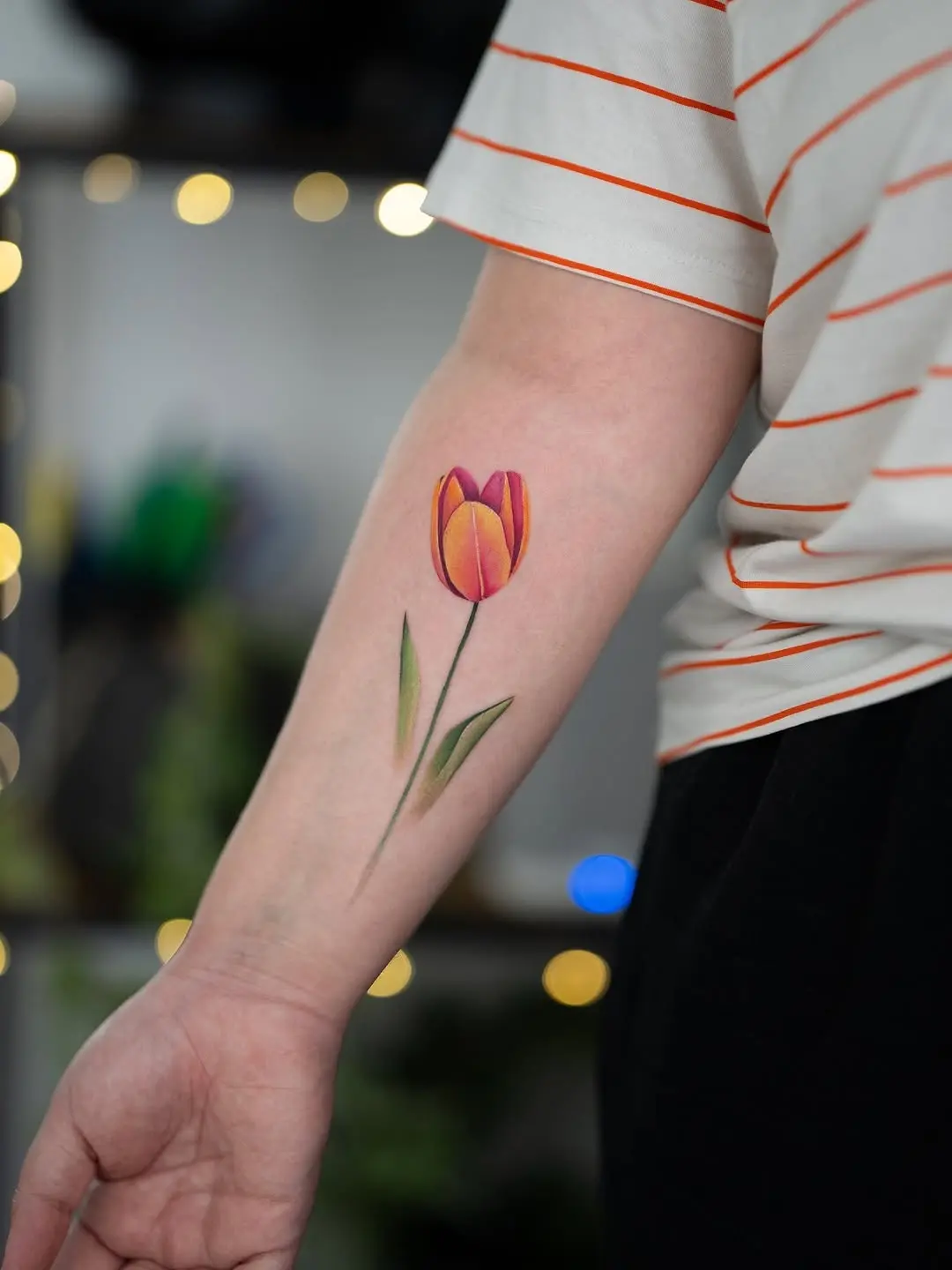 Vibrant tulip tattoo showcasing blooming beauty