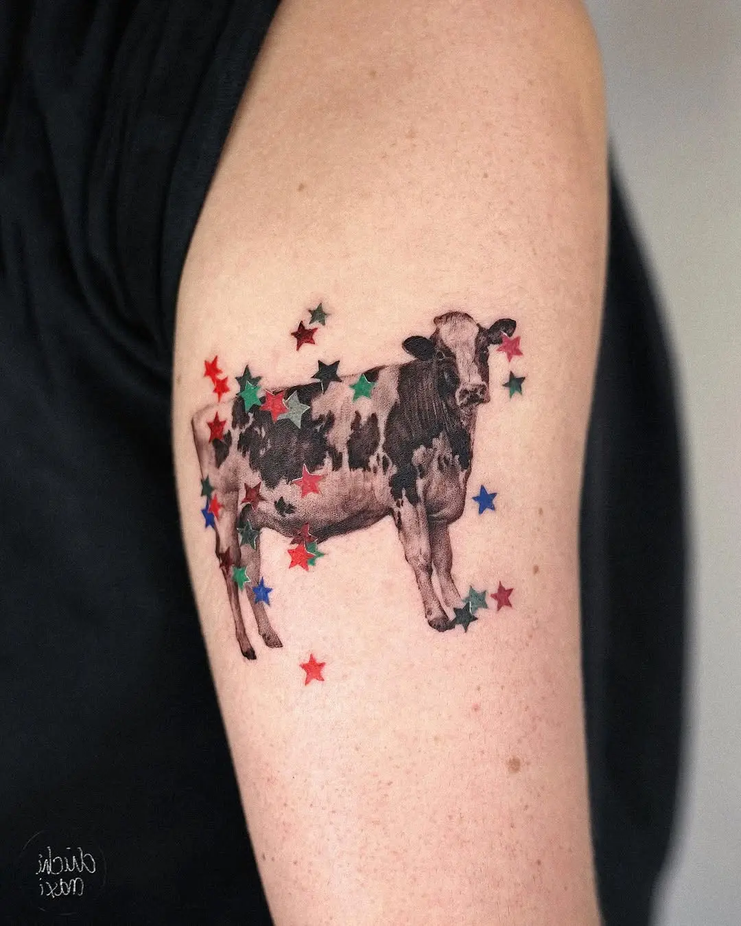Whimsical Cow Tattoo with Colorful Stars