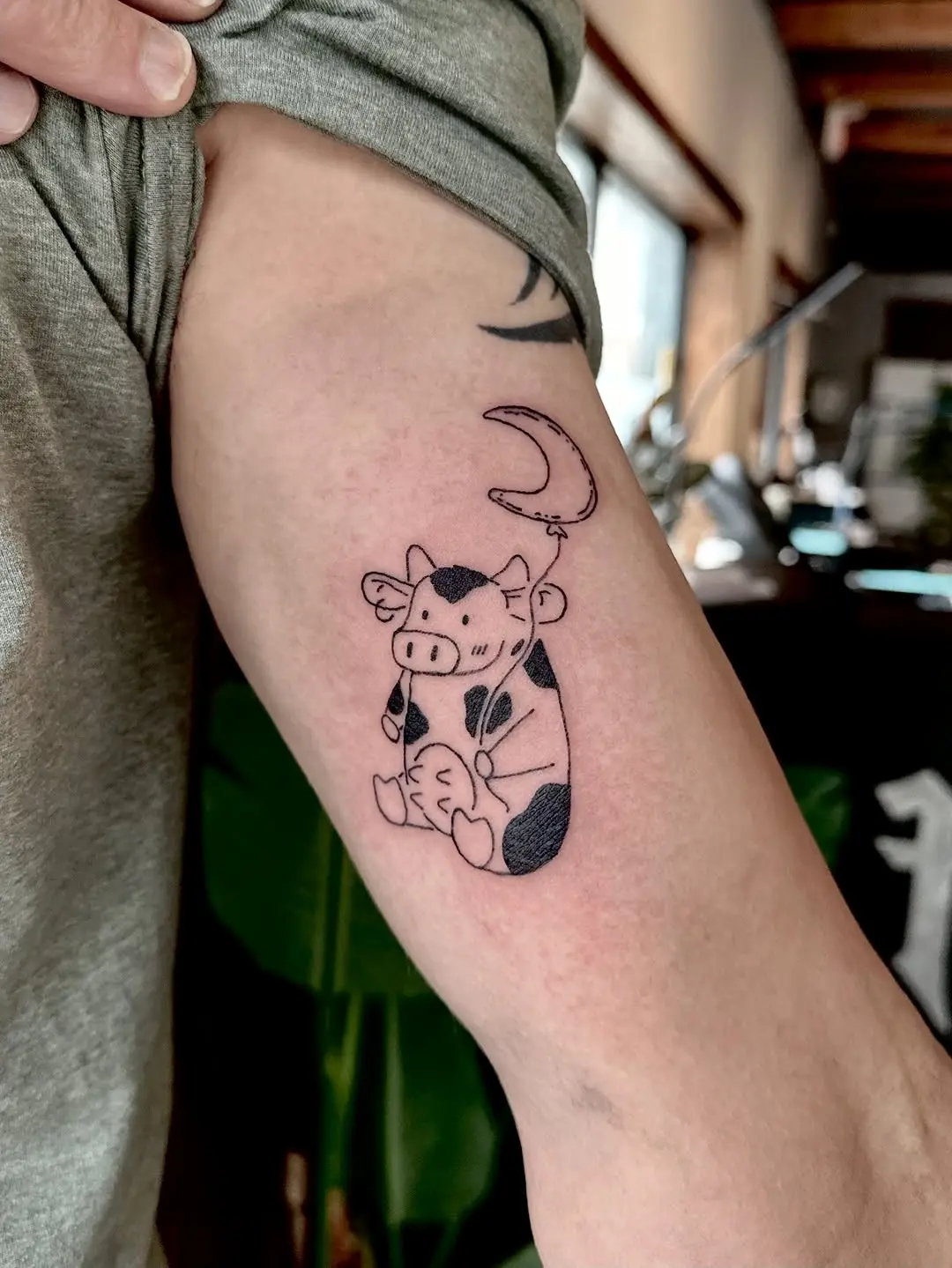 Charming cow tattoo with a crescent moon