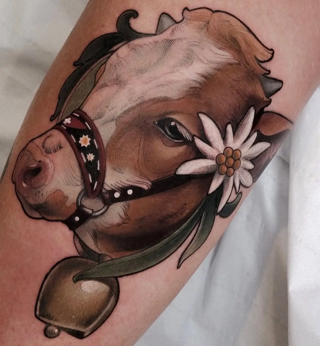 Cow tattoo with floral accents and a bell