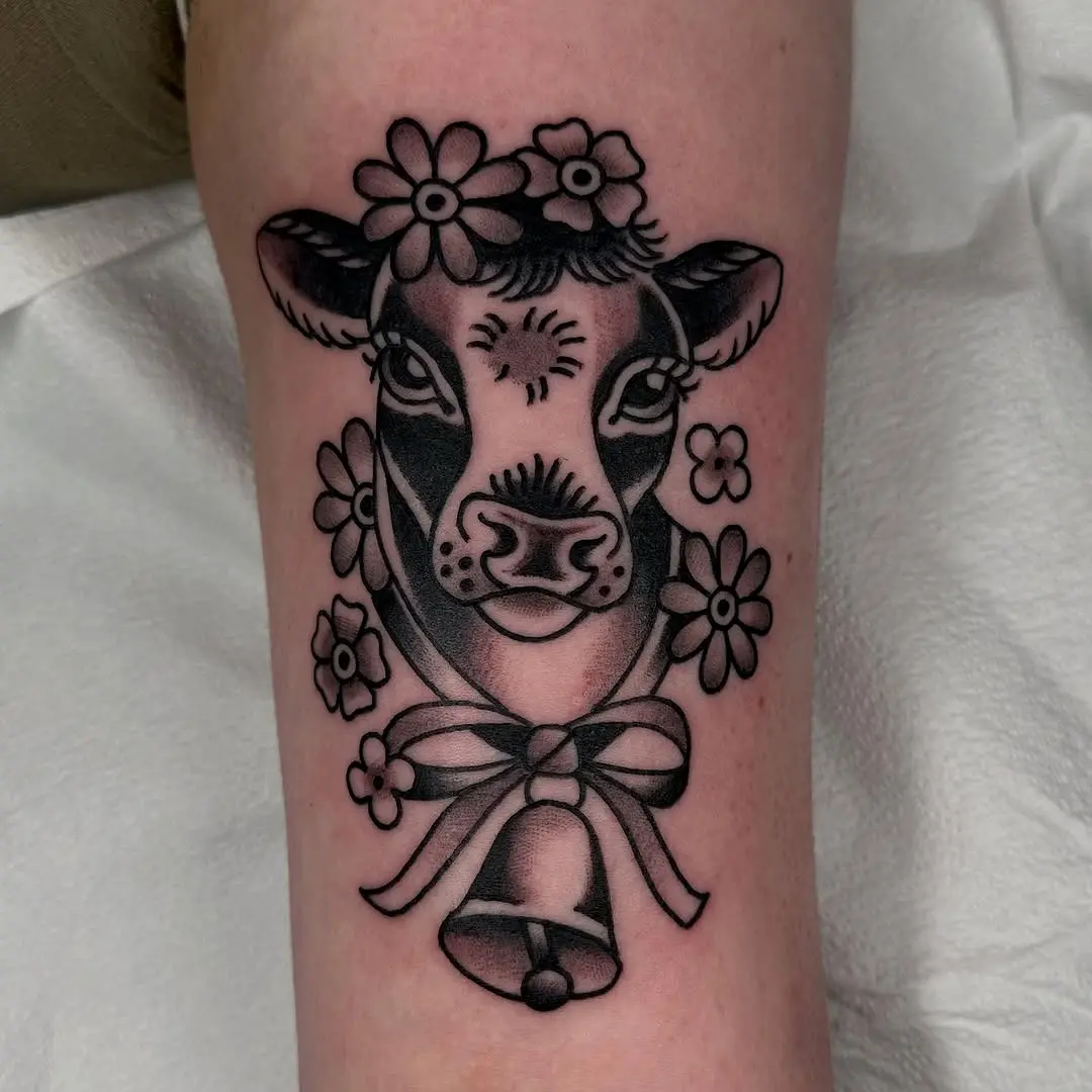 Charming cow tattoo adorned with flowers