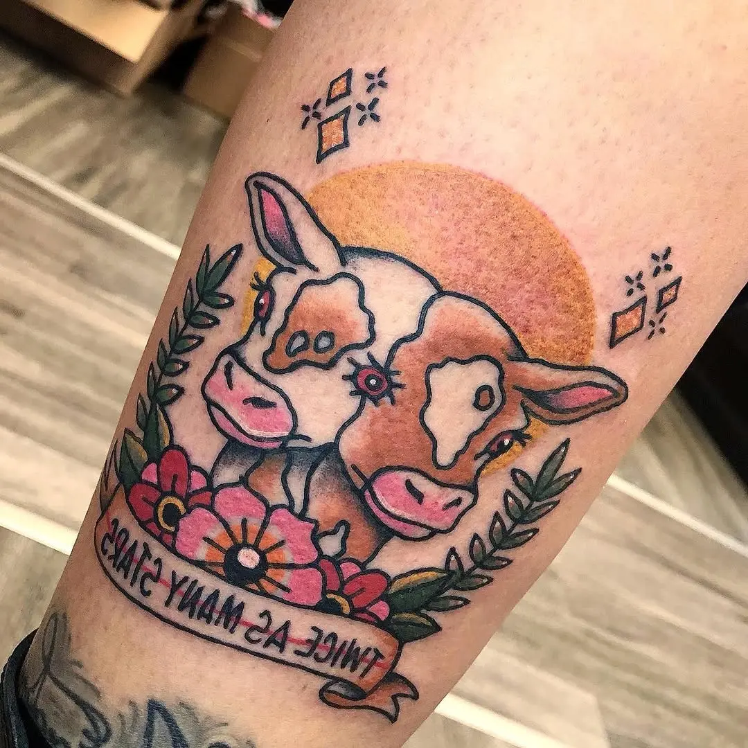 Charming dual cow tattoo with floral elements