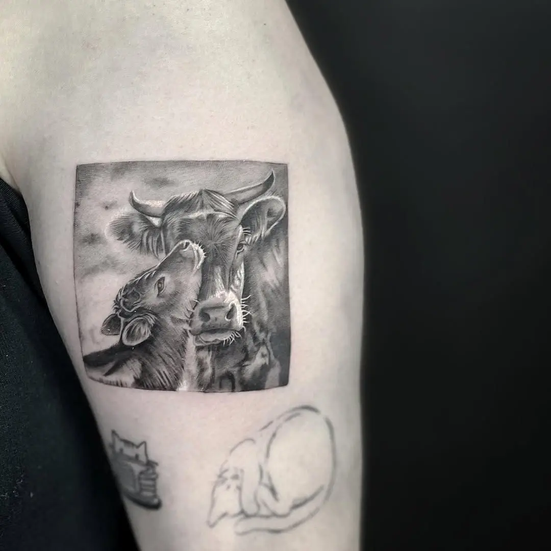 Heartwarming cow tattoo of mother and calf