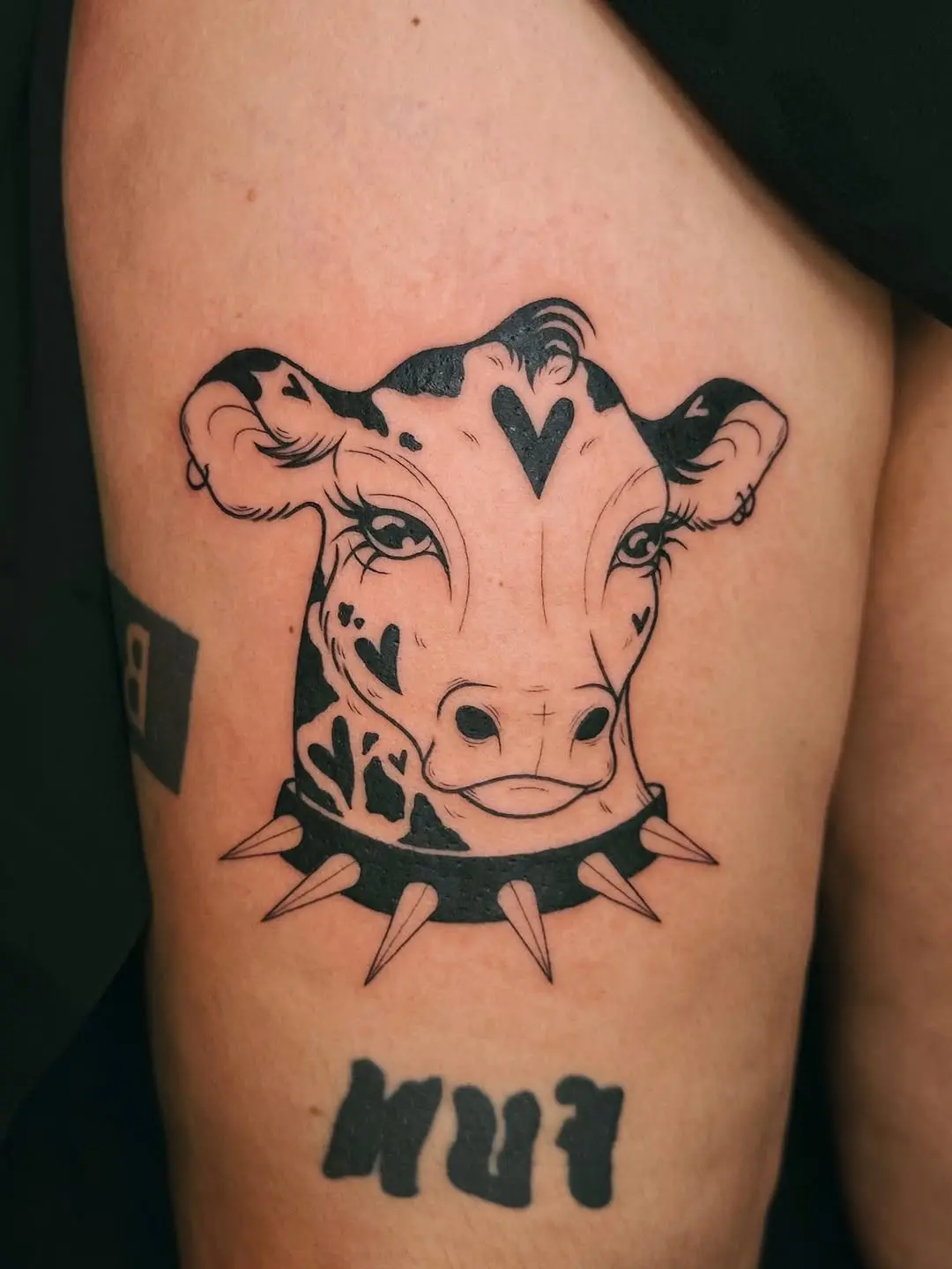 Unique cow tattoo with edgy spiked collar
