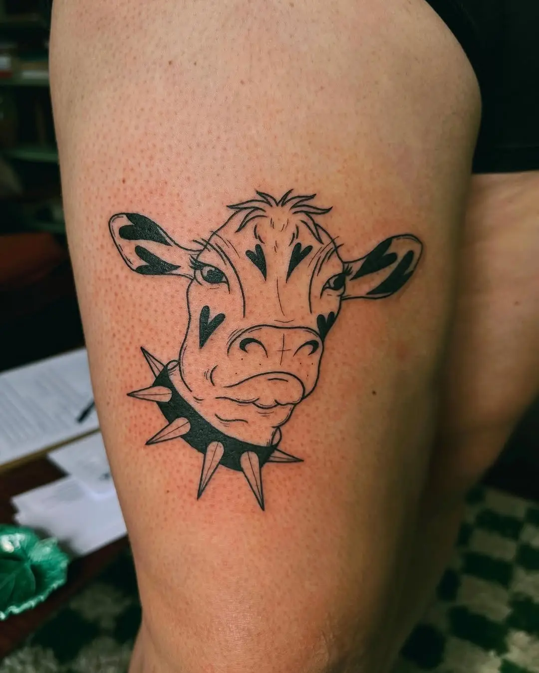 Unique cow tattoo with edgy spikes