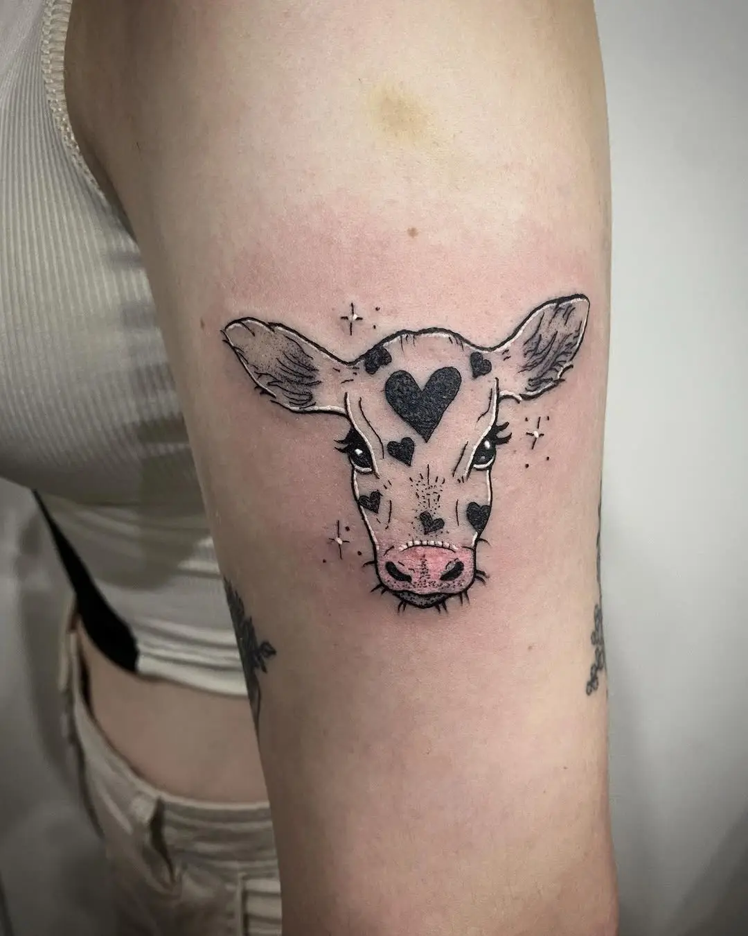 Adorable cow tattoo with hearts and stars