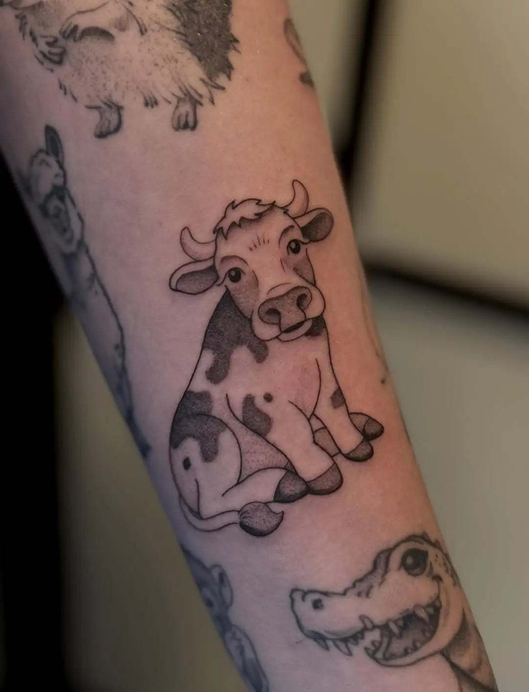Adorable cow tattoo with playful vibes