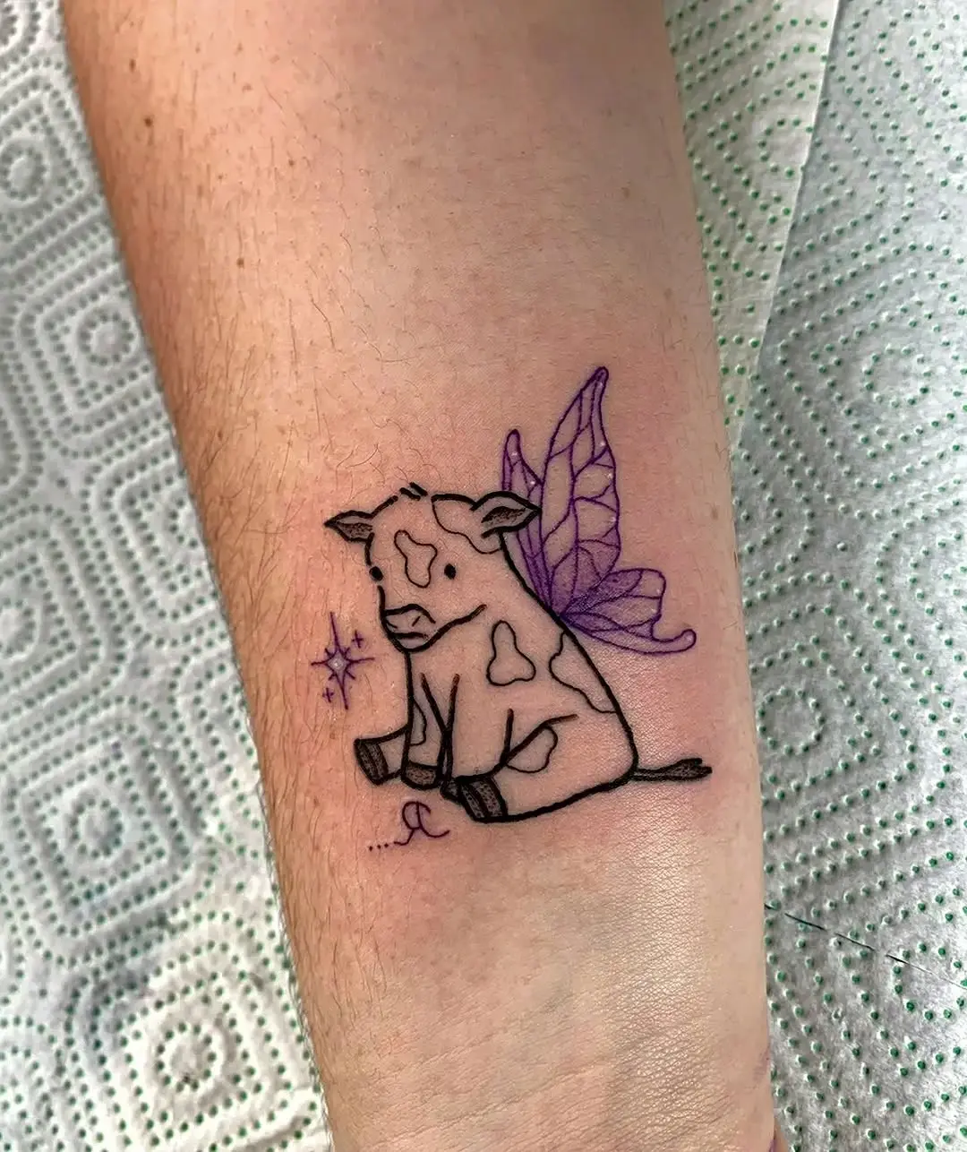 Charming cow tattoo with whimsical wings