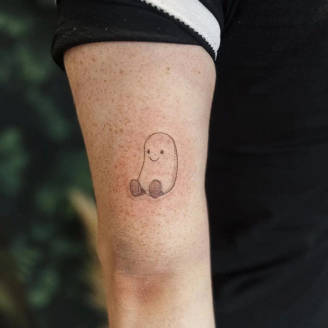 Charming jelly bean tattoo on forearm