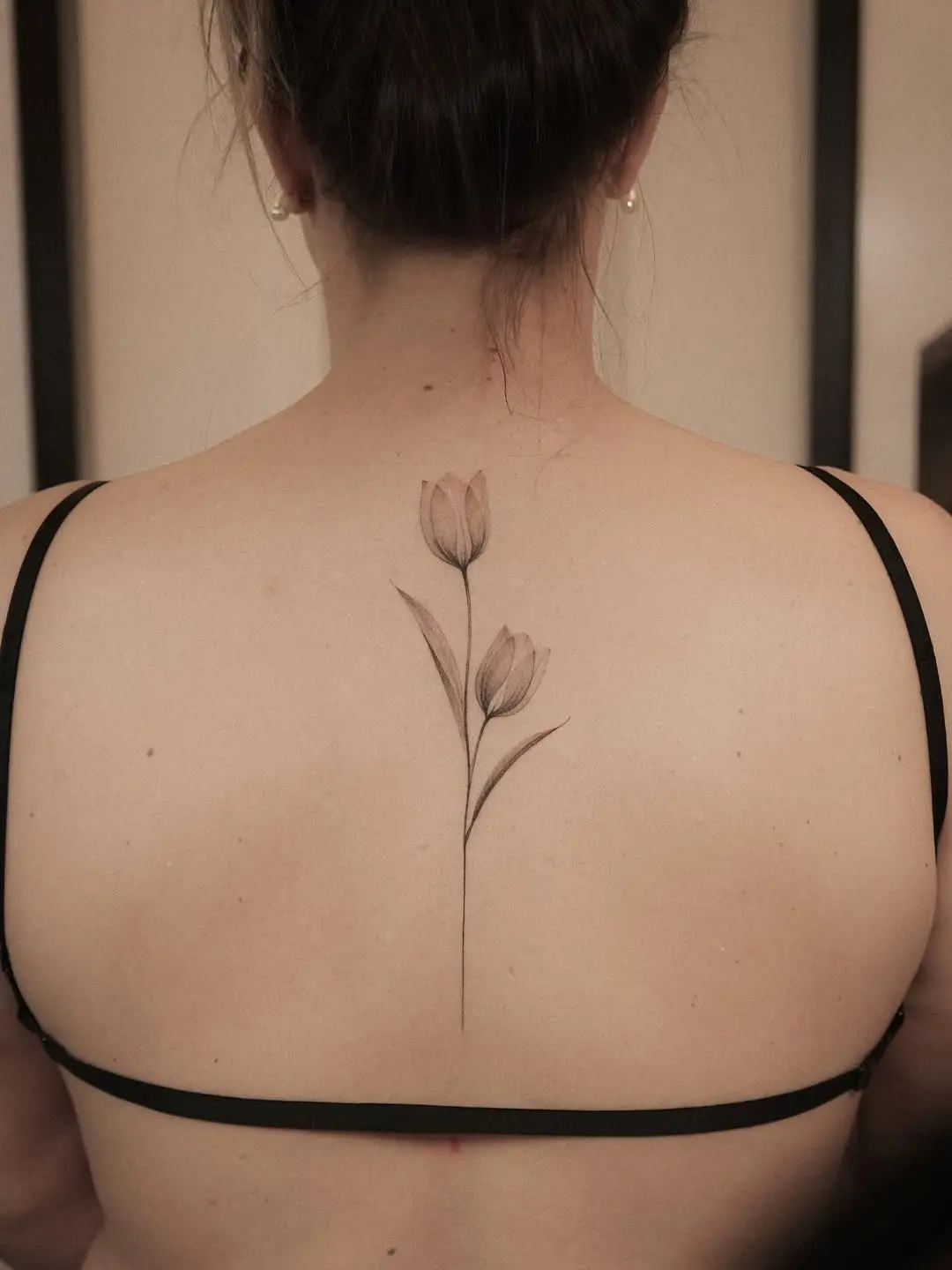Elegant tulip tattoo adorning the back