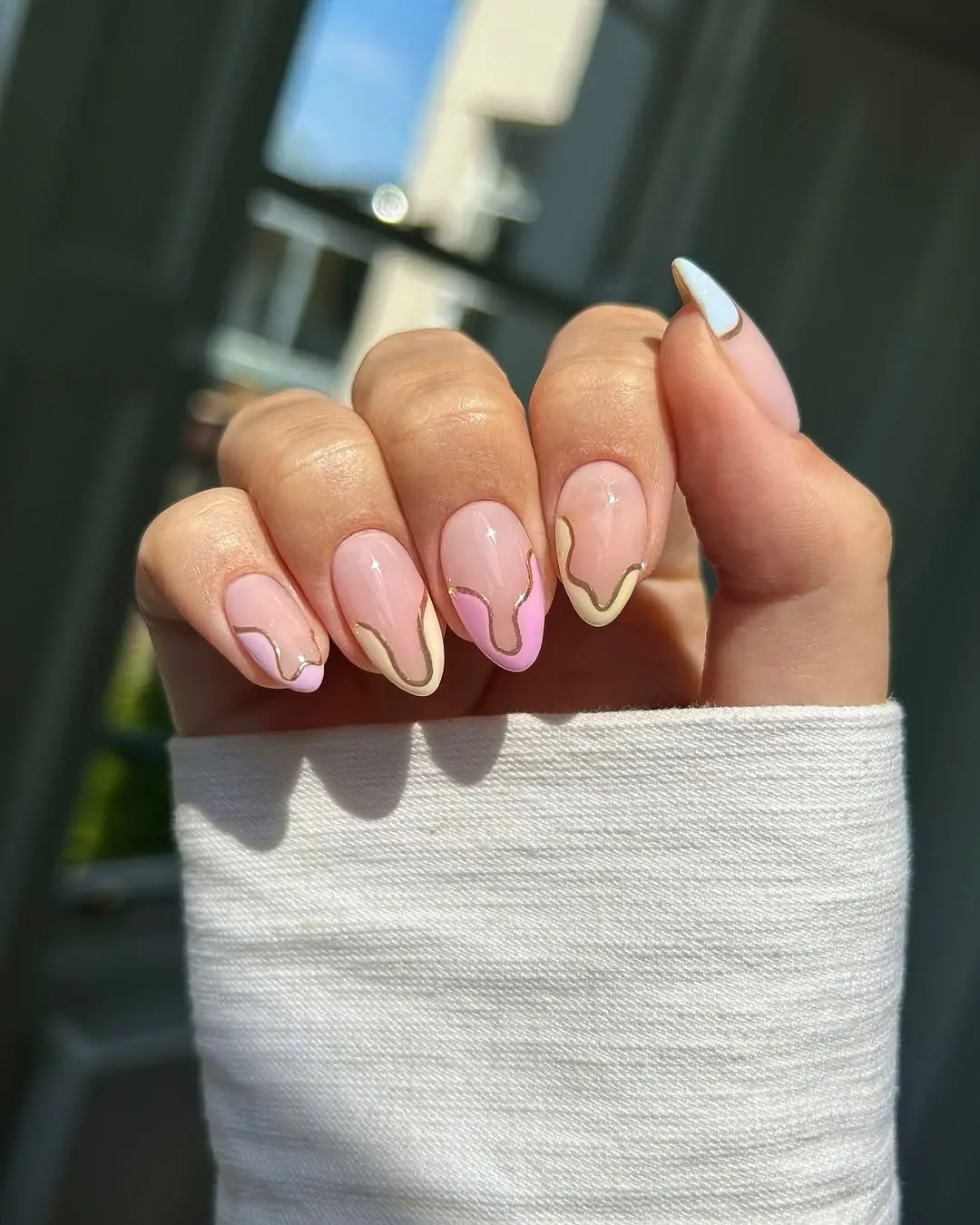 Playful pastel nails with elegant gold accents