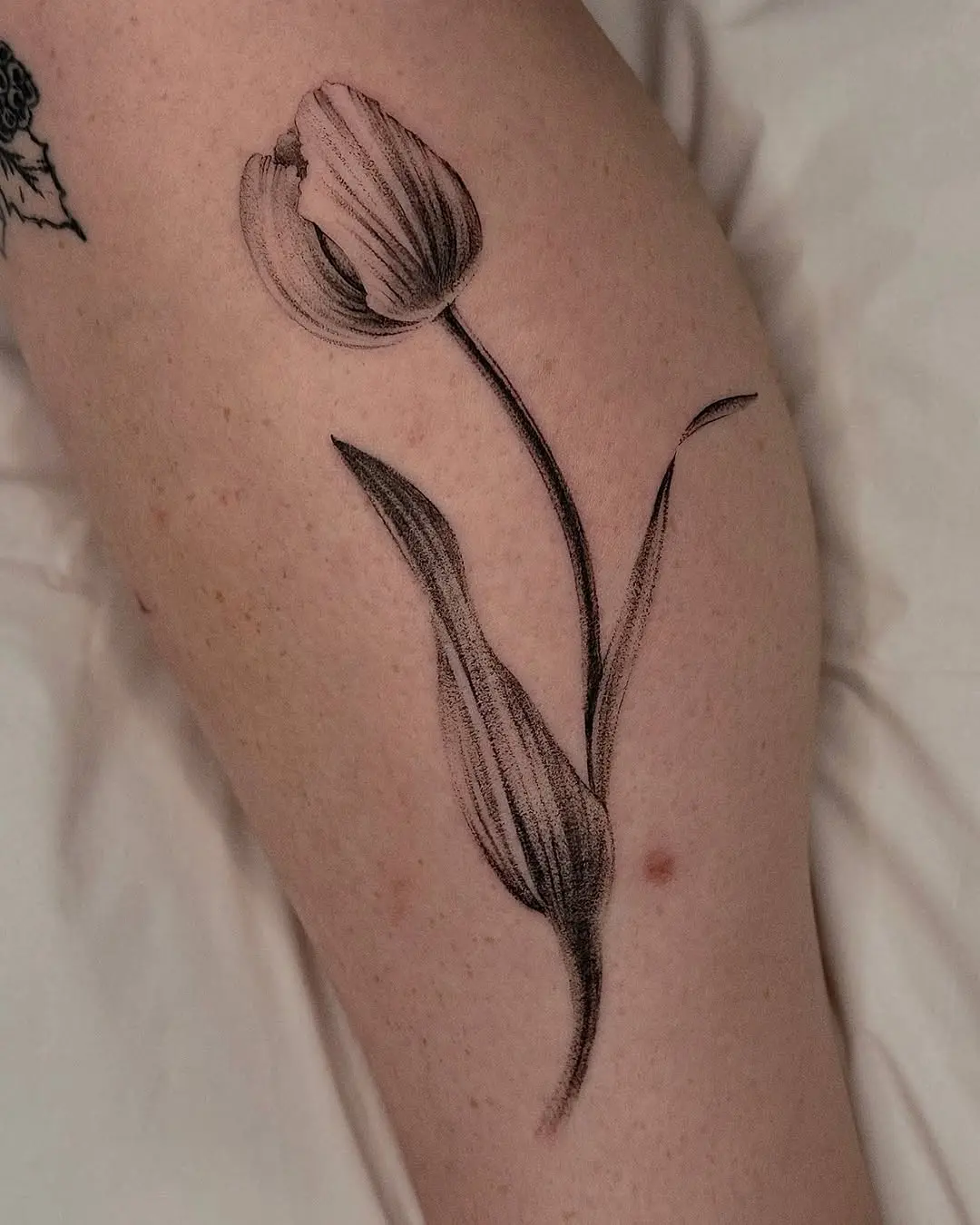 Elegant black and white tulip tattoo design