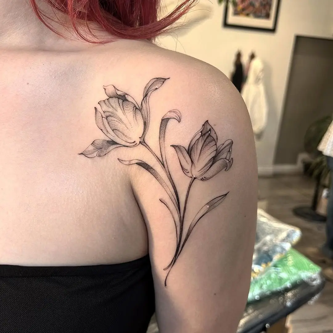 Delicate tulip tattoo on shoulder for elegance