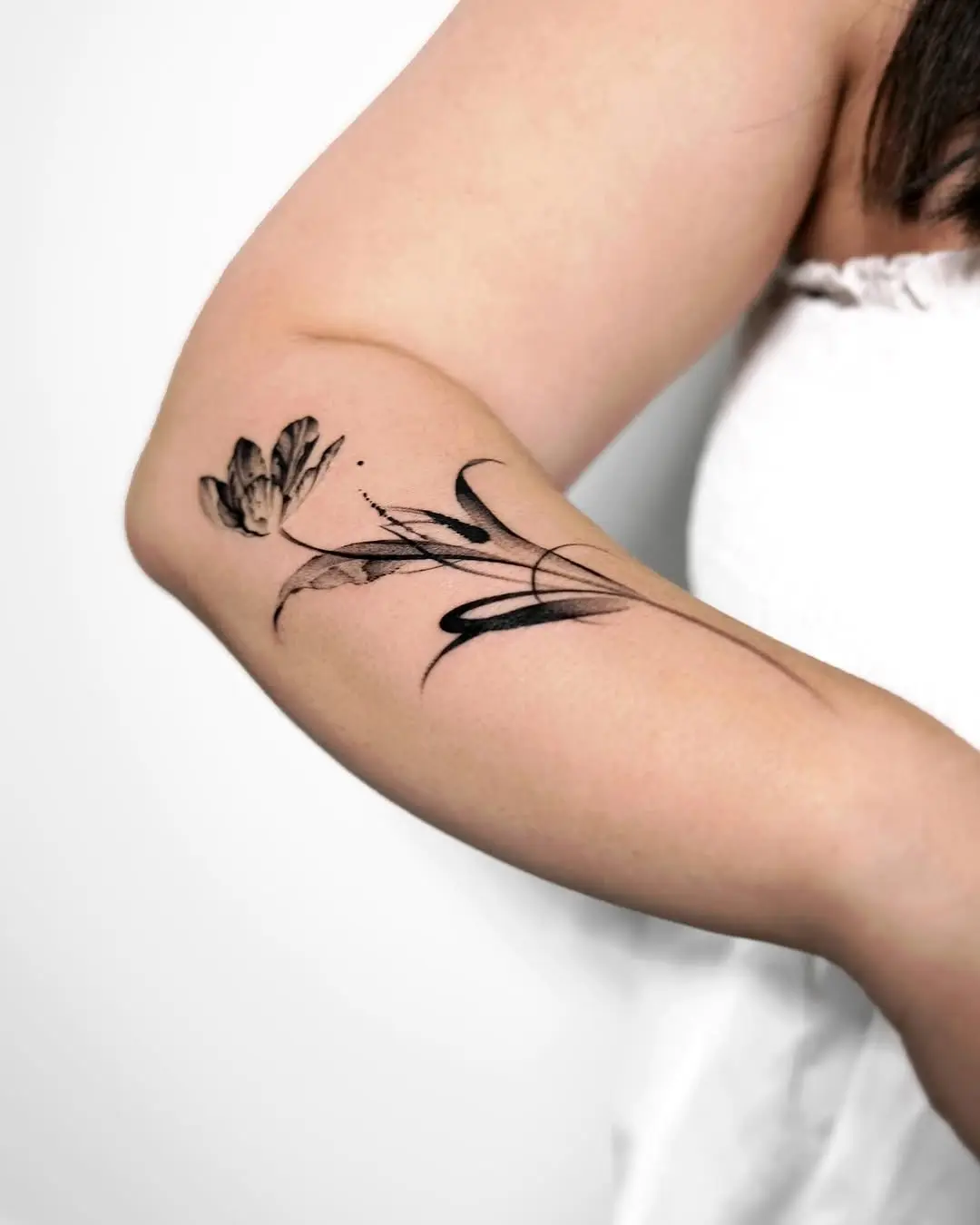 Delicate tulip tattoo with artistic flair
