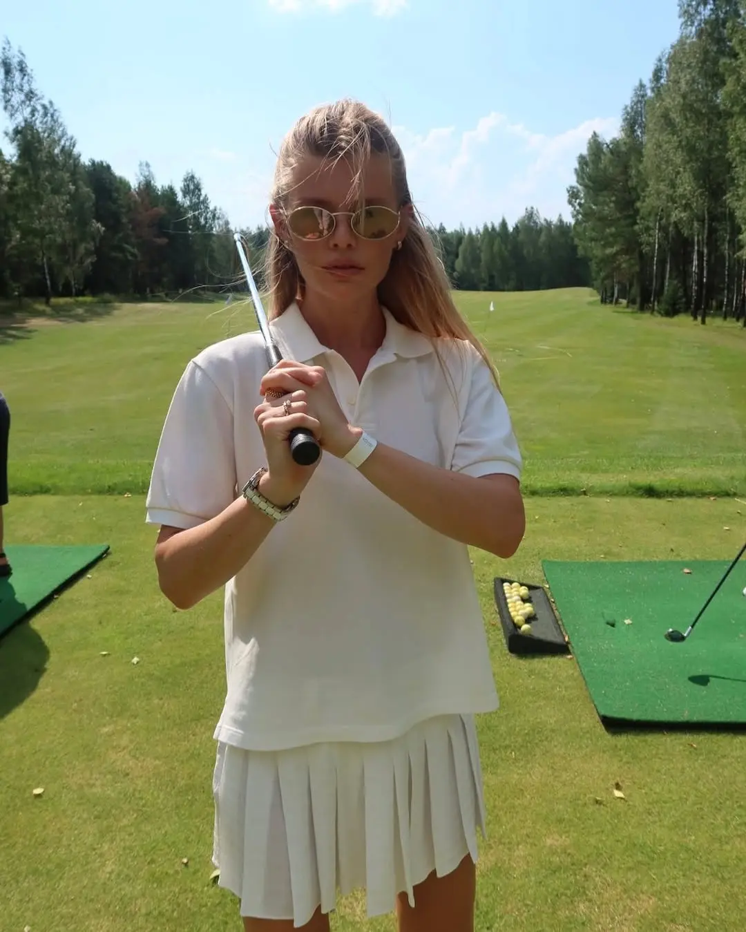 Chic white golf outfit with stylish accessories