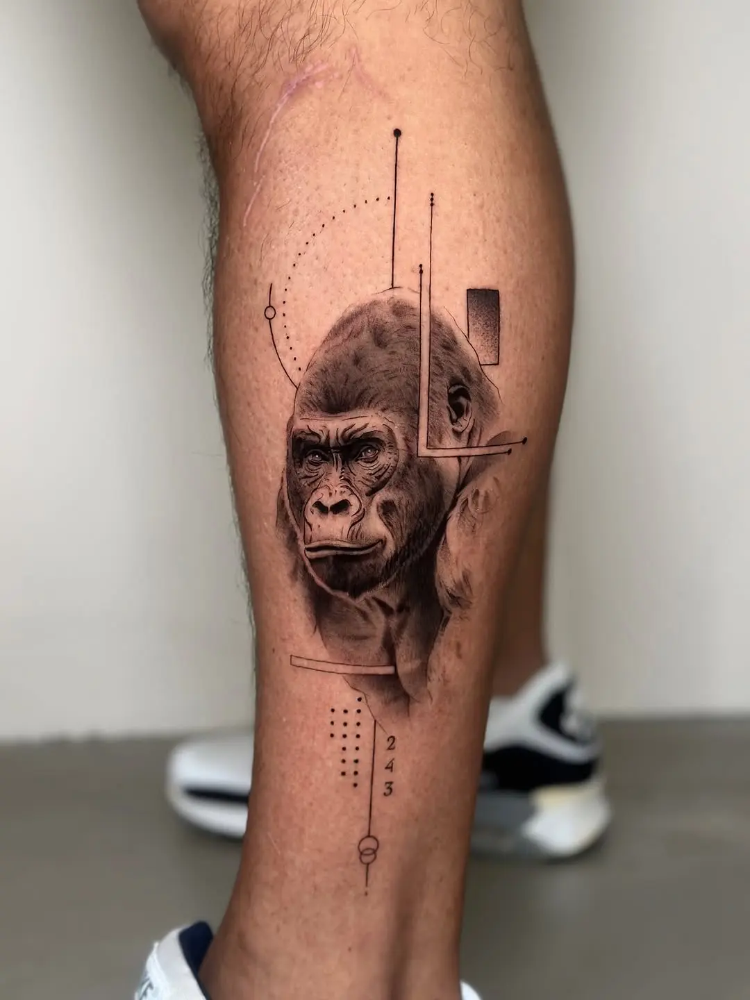 Captivating gorilla leg tattoo blending realism and art