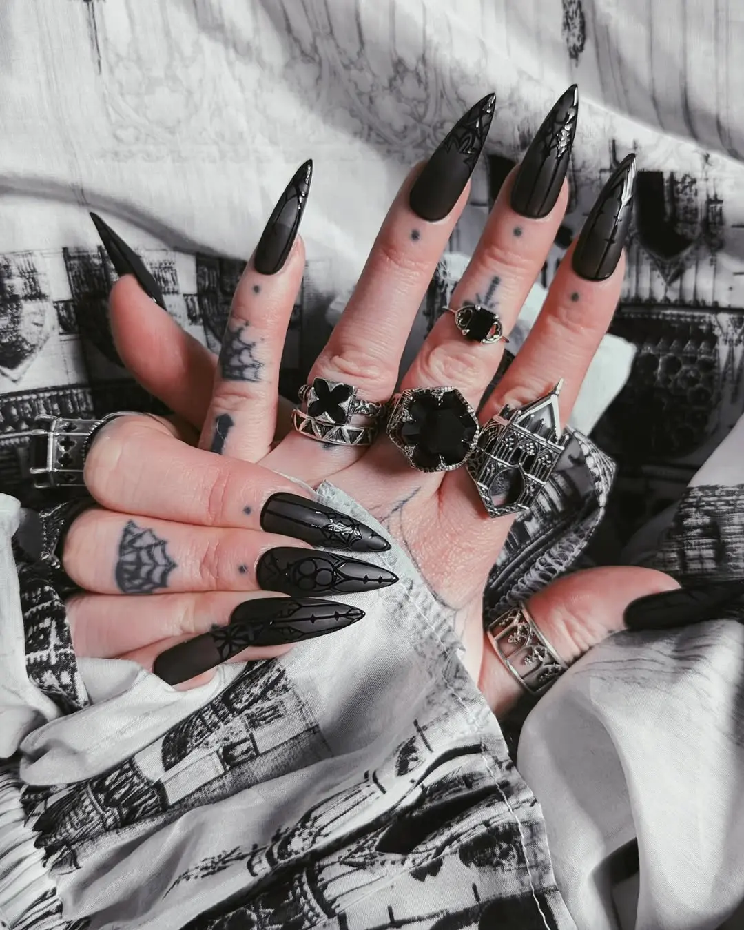 Chic gothic nails with intricate black designs