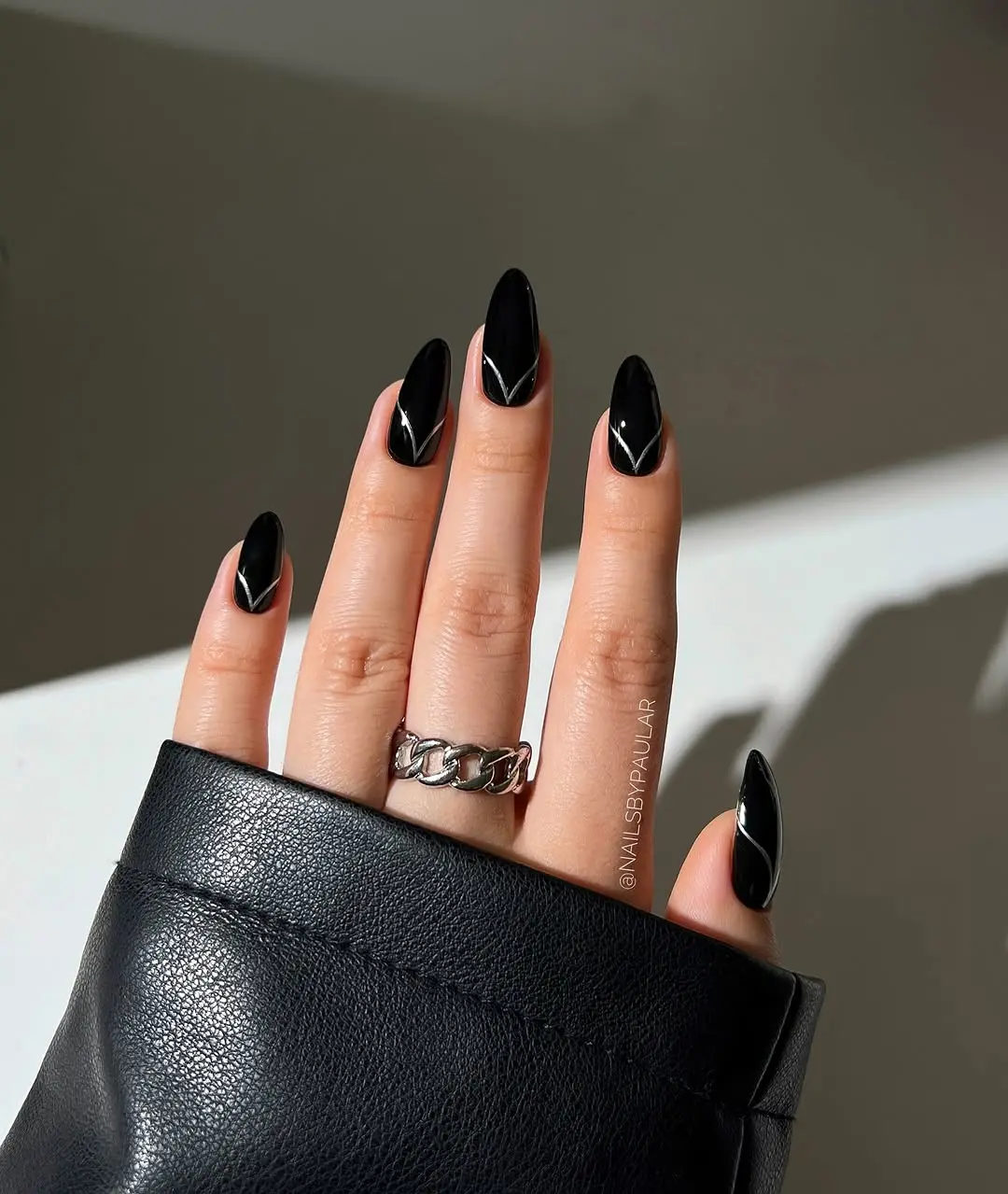 Sleek black gothic nails with striking design