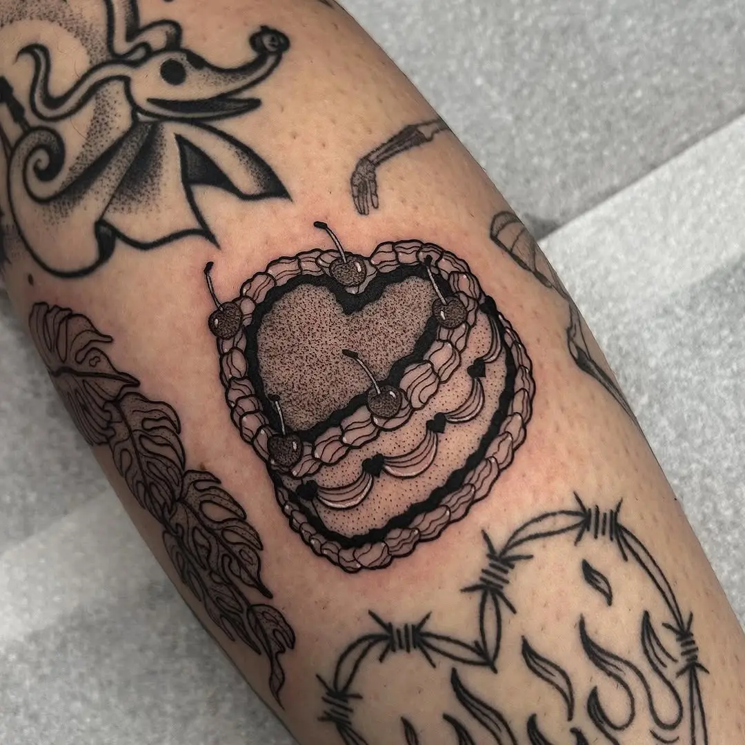 Delicate heart-shaped cake tattoo design