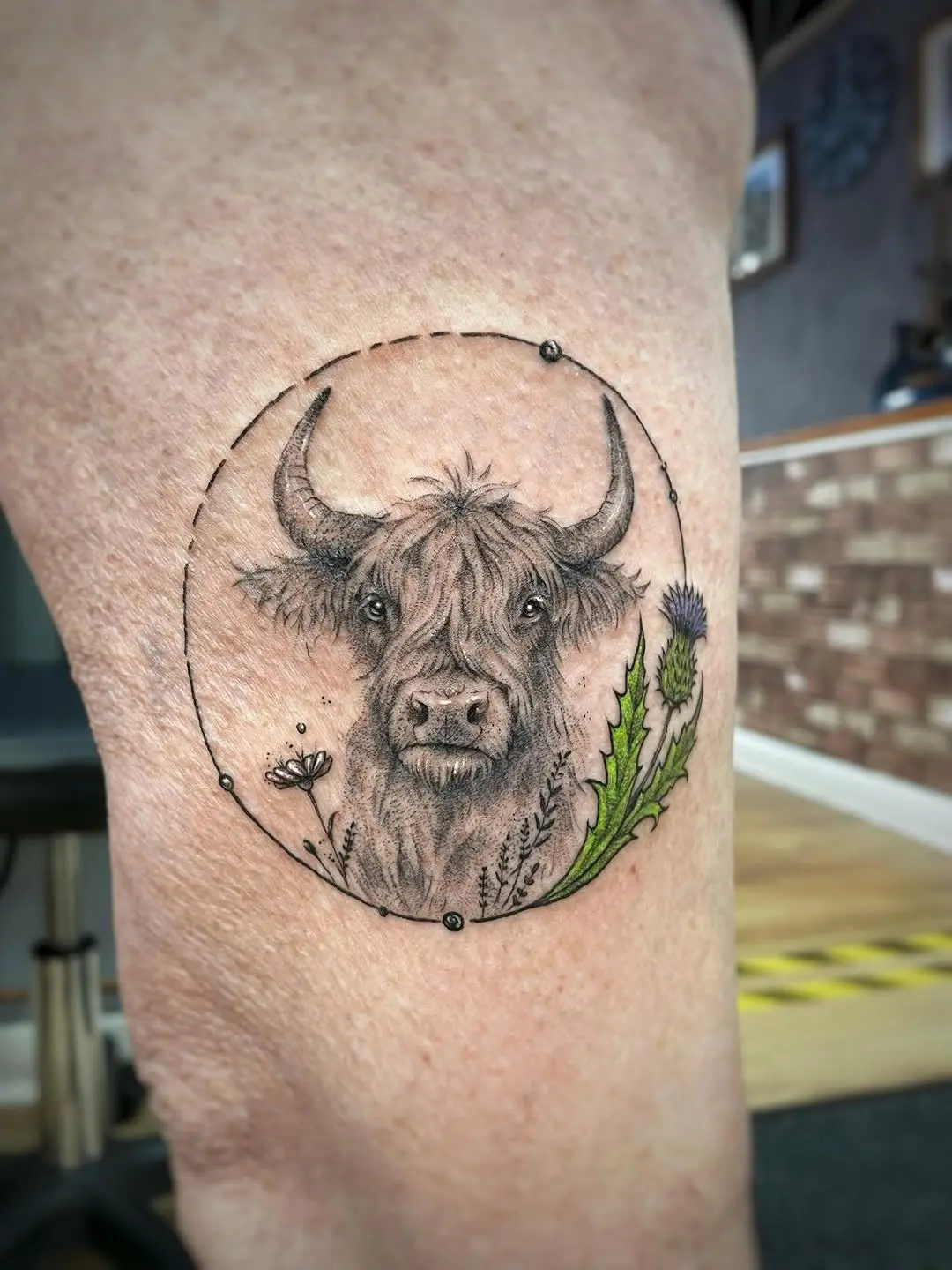 Charming highland cow tattoo with floral elements