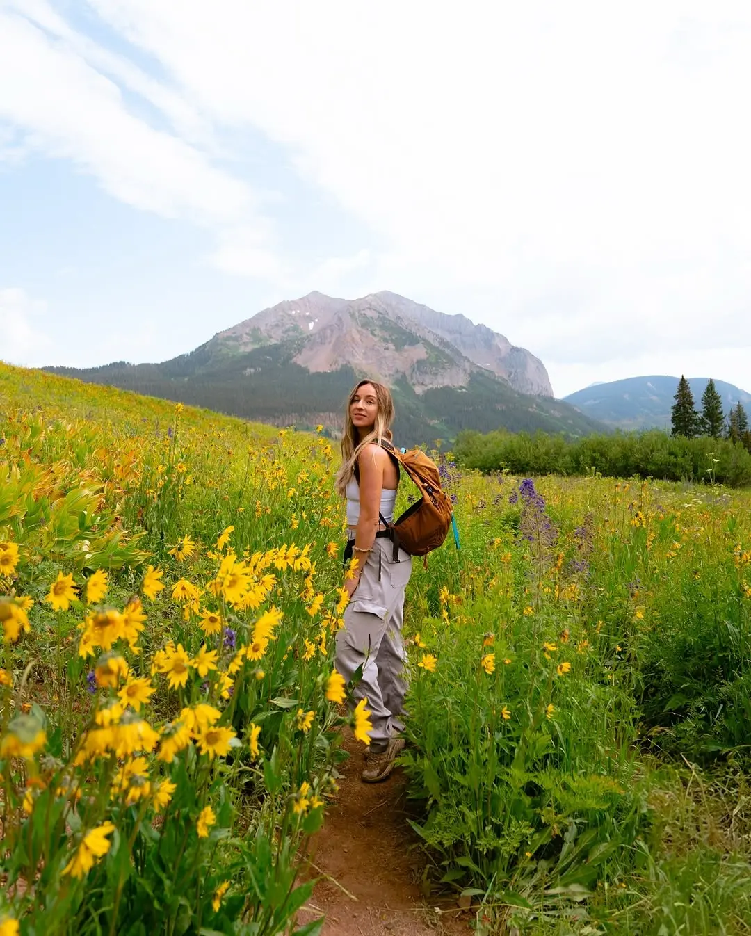 Stylish Hiking Outfit Amidst Blooming Flowers