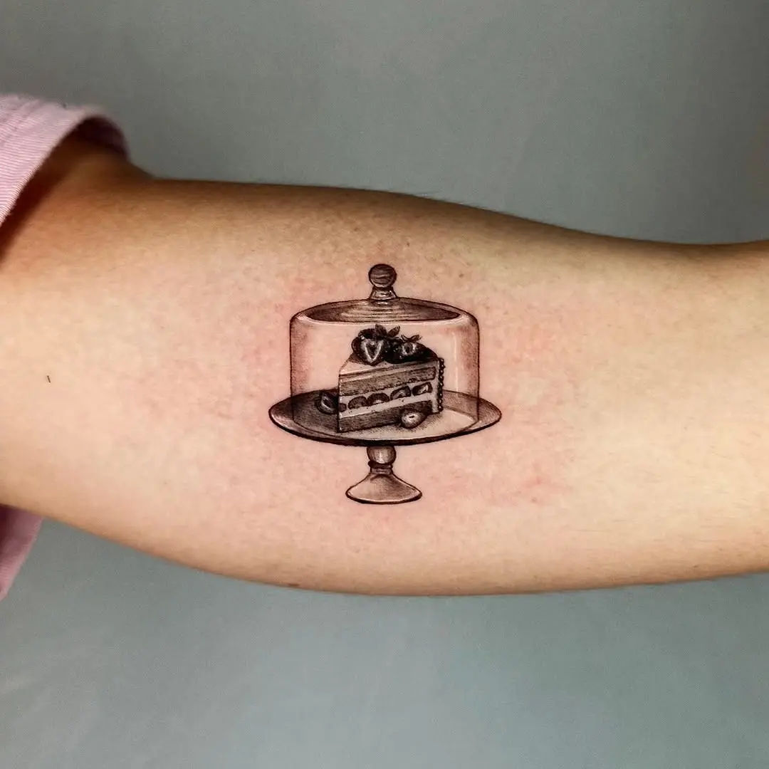 An elegant cake tattoo in a glass dome