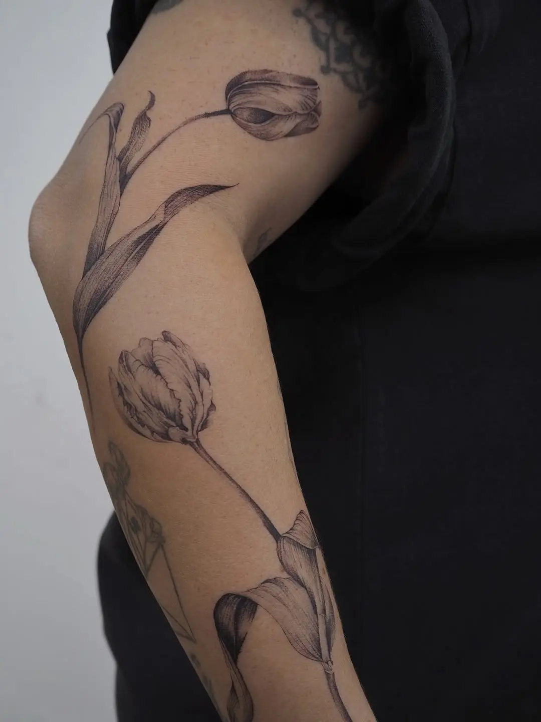 Elegant floral tattoo design featuring tulips