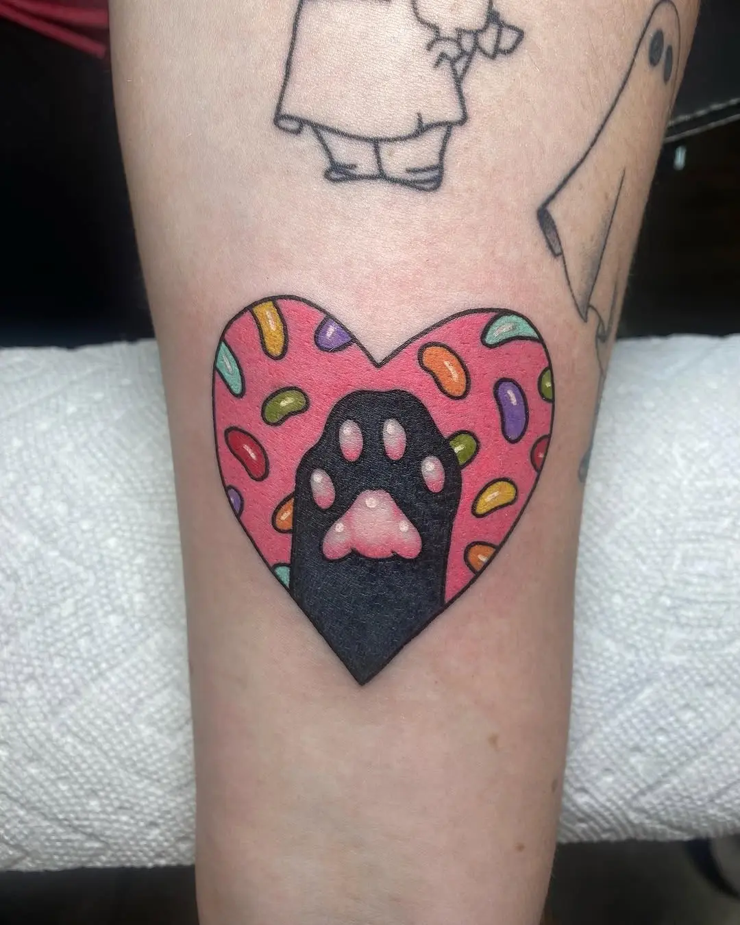 Playful jelly bean paw heart tattoo concept