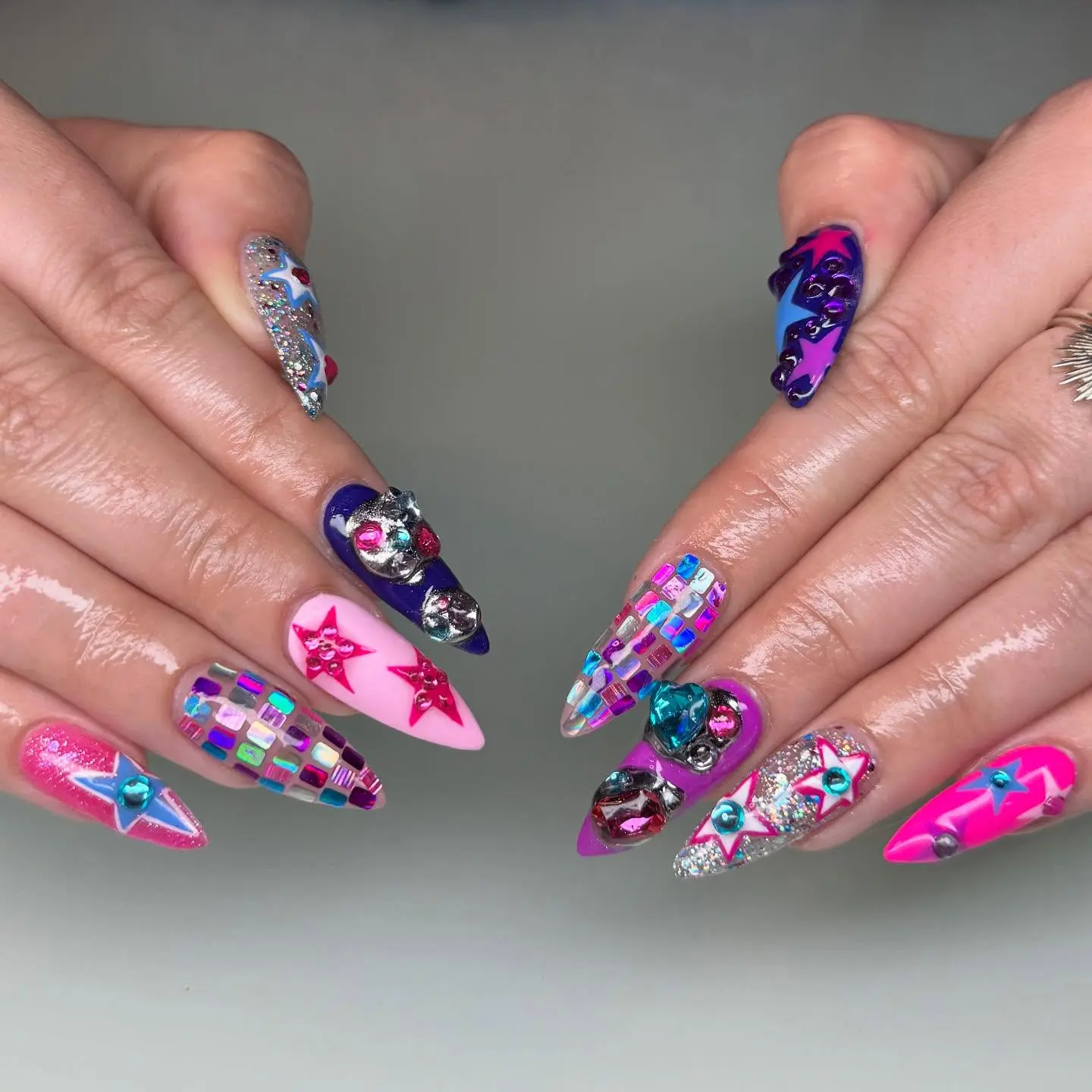 Vibrant stiletto nails with unique embellishments