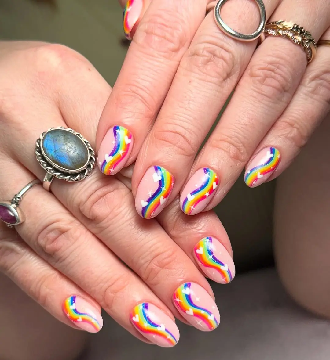 Vibrant rainbow wave nail art for pride.