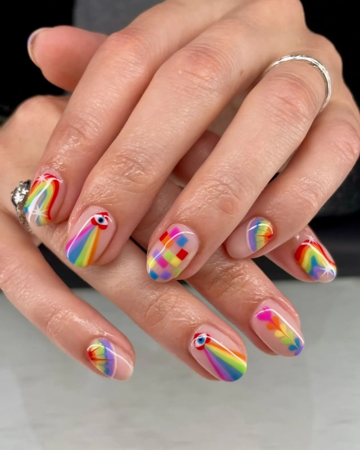 Vibrant rainbow nails with playful patterns