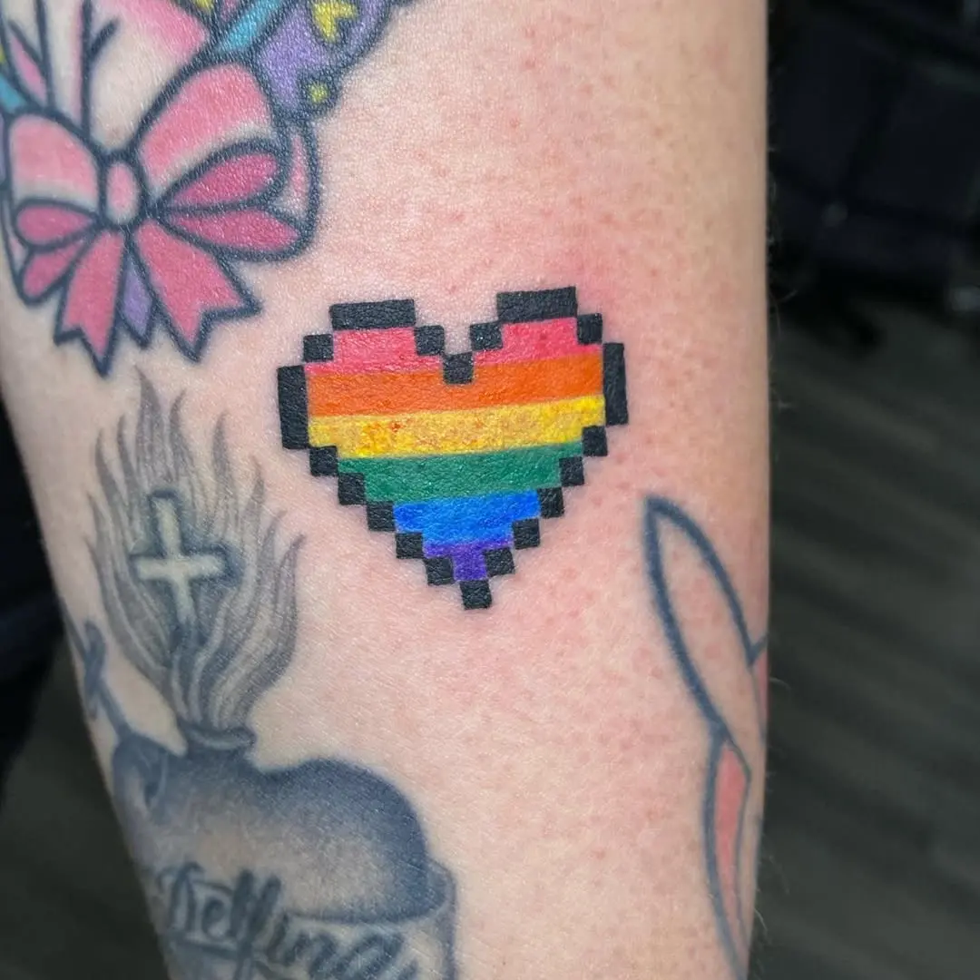Colorful pixel heart tattoo celebrating love.