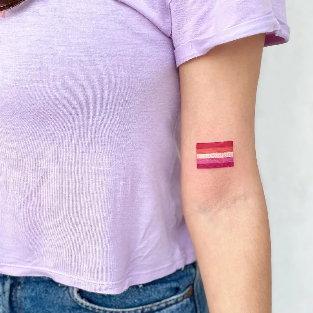 Minimalist tattoo showcasing vibrant pride colors