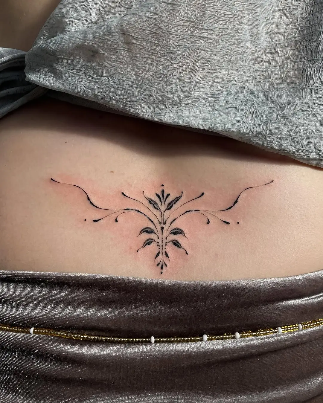 Elegant floral design gracing the lower back.