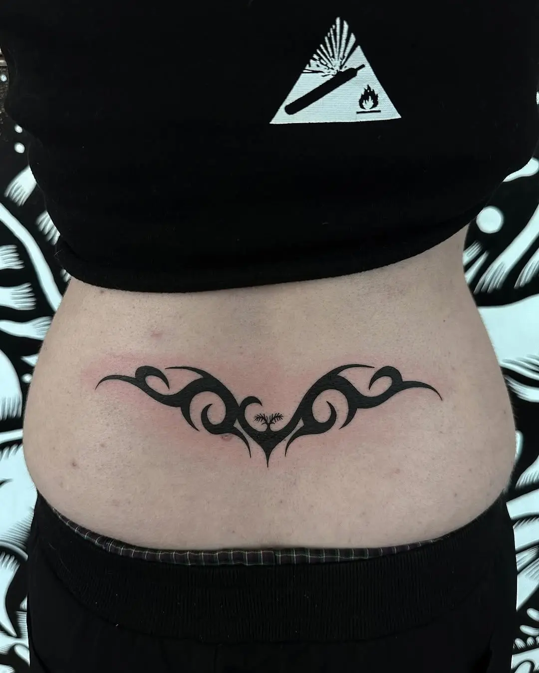 Elegant black curves adorn lower back