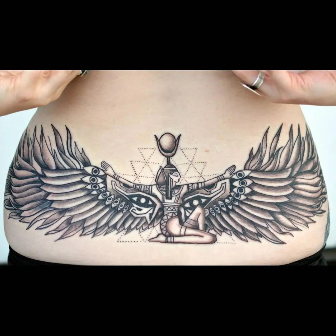 Stunning lower back tattoo with intricate wings