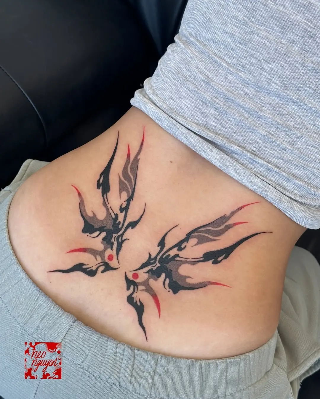 Stylish flame butterfly lower back tattoo design
