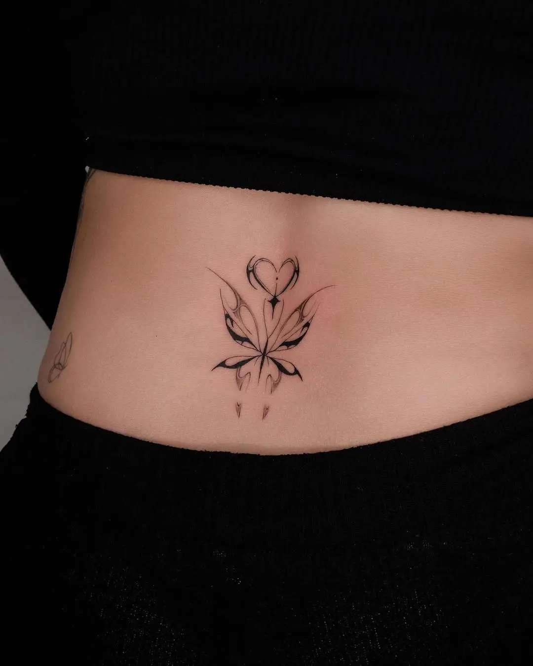 Elegant floral heart lower back tattoo design