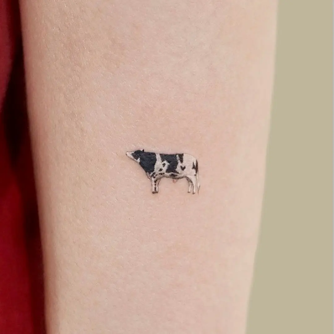 Stylish minimalist black and white cow tattoo