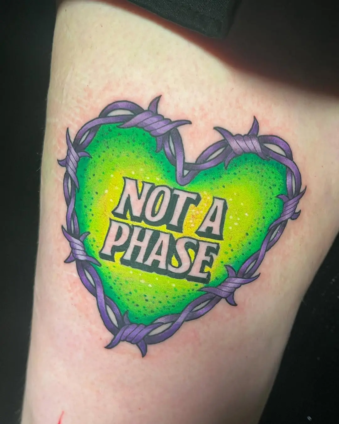Vibrant heart tattoo with bold statement