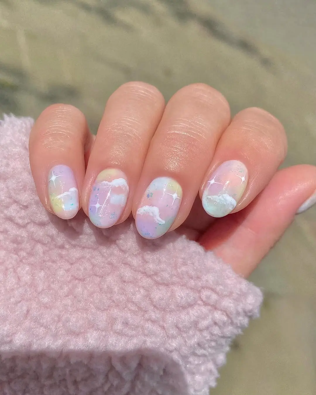 Whimsical pastel cloud nail art in soft shades