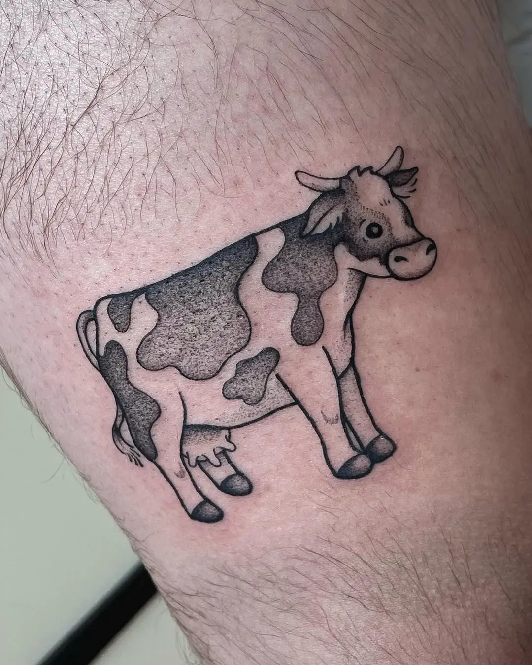 Charming cow tattoo with playful details