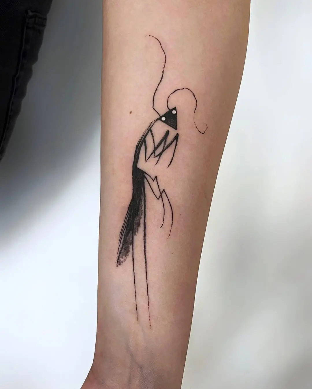 Elegant minimalist praying mantis tattoo in black ink