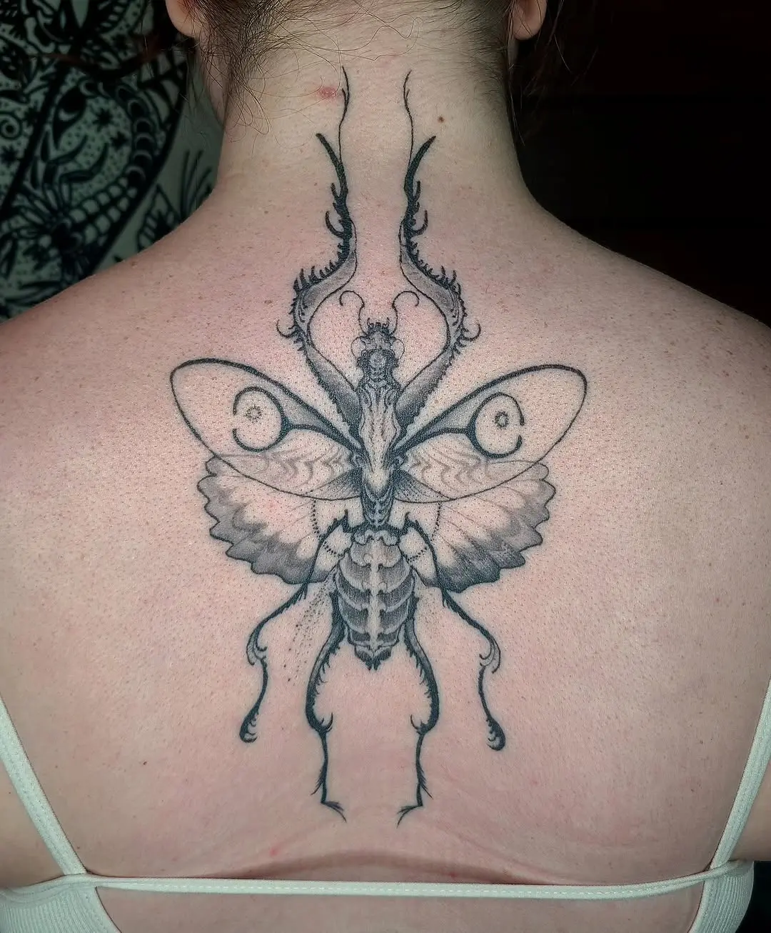 Stylish praying mantis tattoo with intricate details