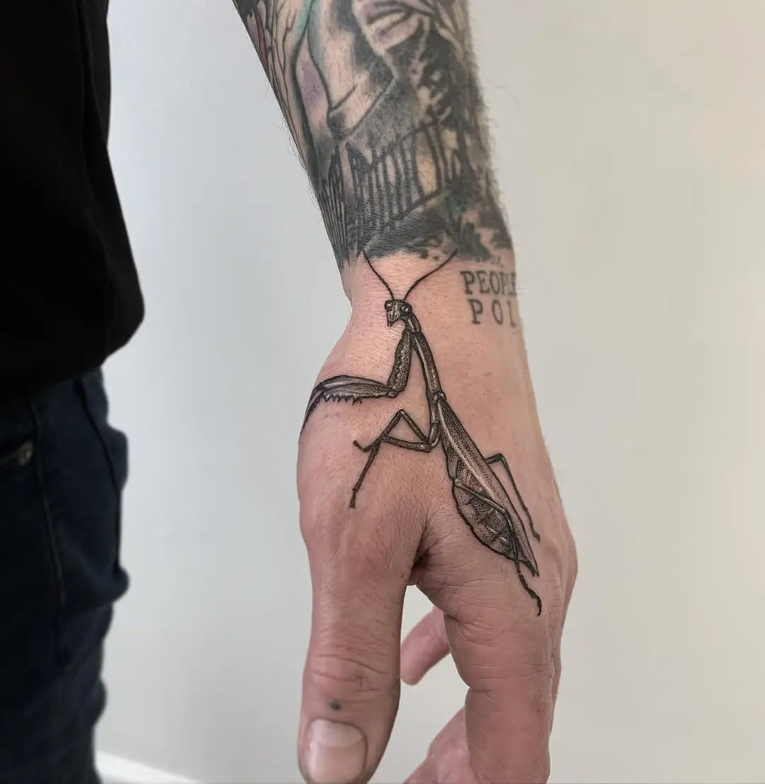 Realistic praying mantis tattoo on forearm