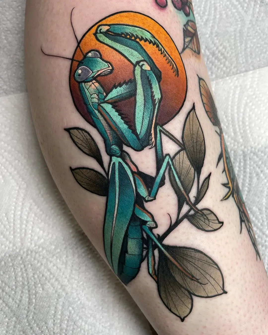 Vibrant praying mantis tattoo with unique colors